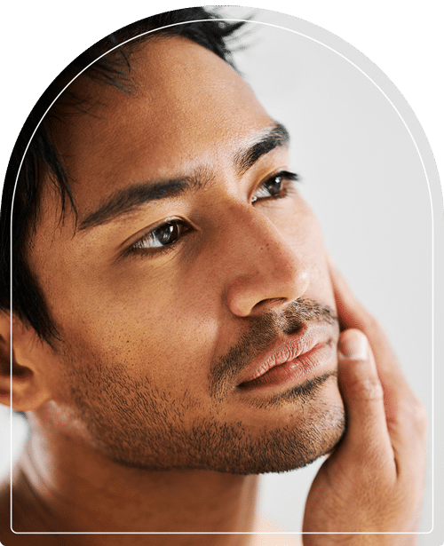 A man rubbing his facial skin