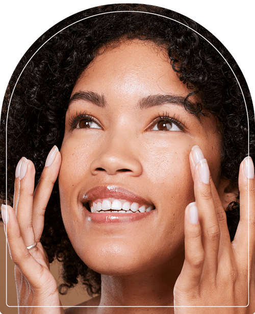 A woman rubbing her smooth facial skin