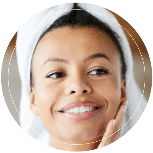 Young woman rubbing her smooth facial skin